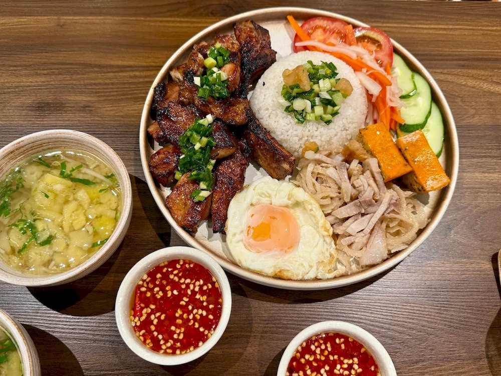 The broken rice here stands out with tender, flavorful pork jowl, perfectly paired with egg meatloaf, shredded pork skin, and a runny fried egg